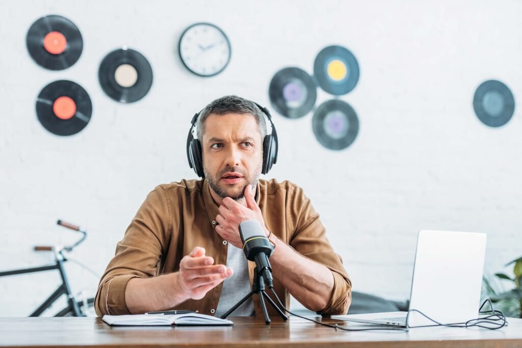 thoughtful-radio-host-in-headphones-recording-podc-F97EPZ3.jpg